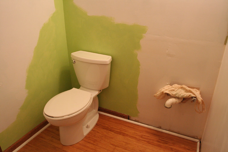 half bathroom - primed and painted behind the new water saver toilet